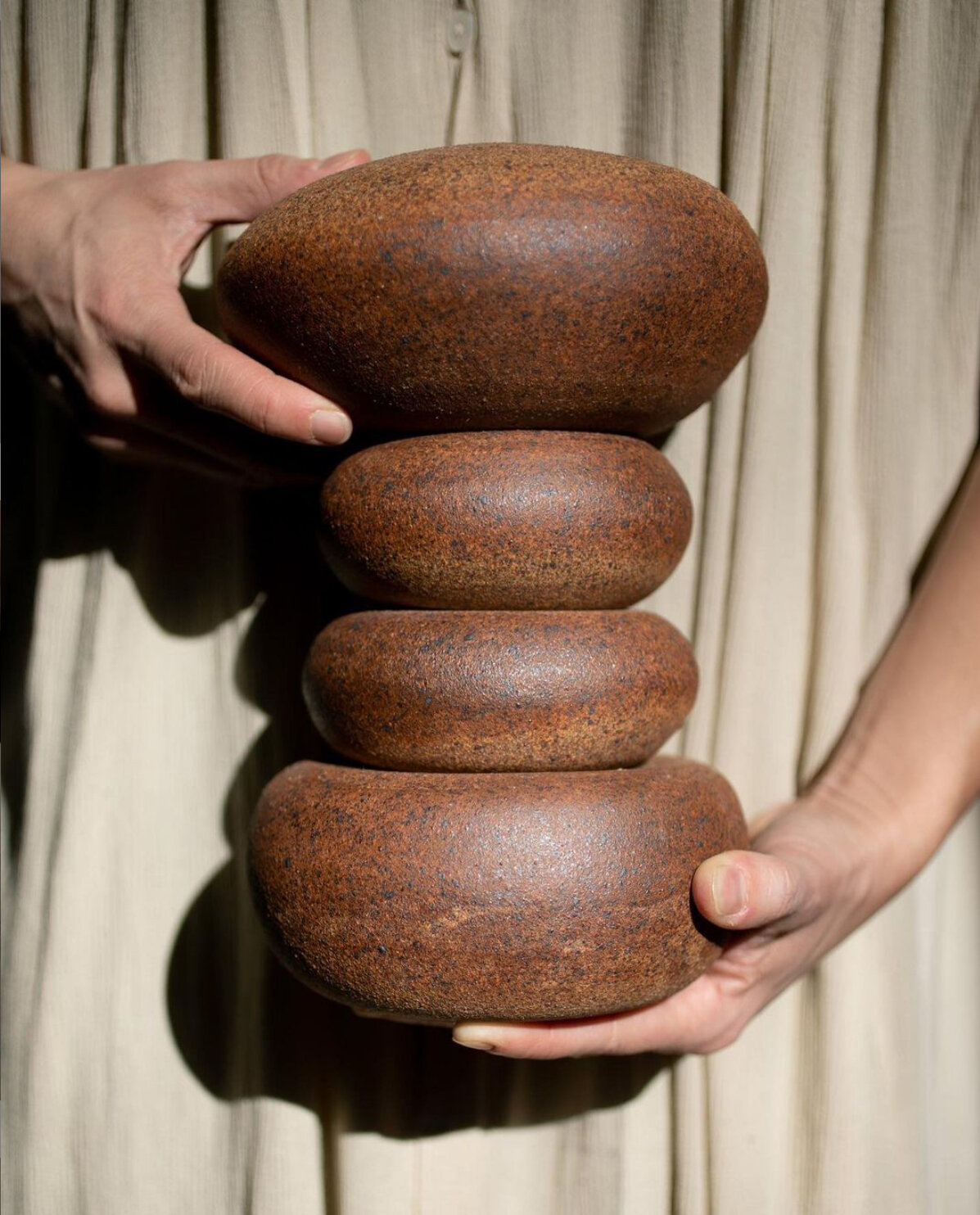 A clay cairn is one of Katherine’s sculptural series that metaphorically embodies the ideal life balance as well as reminds the viewer that life is a journey—look for the guides along the path. Photo credit: James Moes