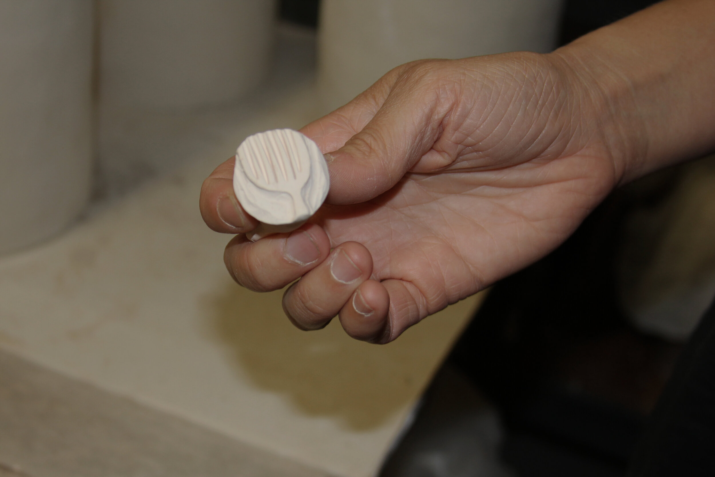 One of the stamps she has recently created for decorating the surfaces of her coil pots.